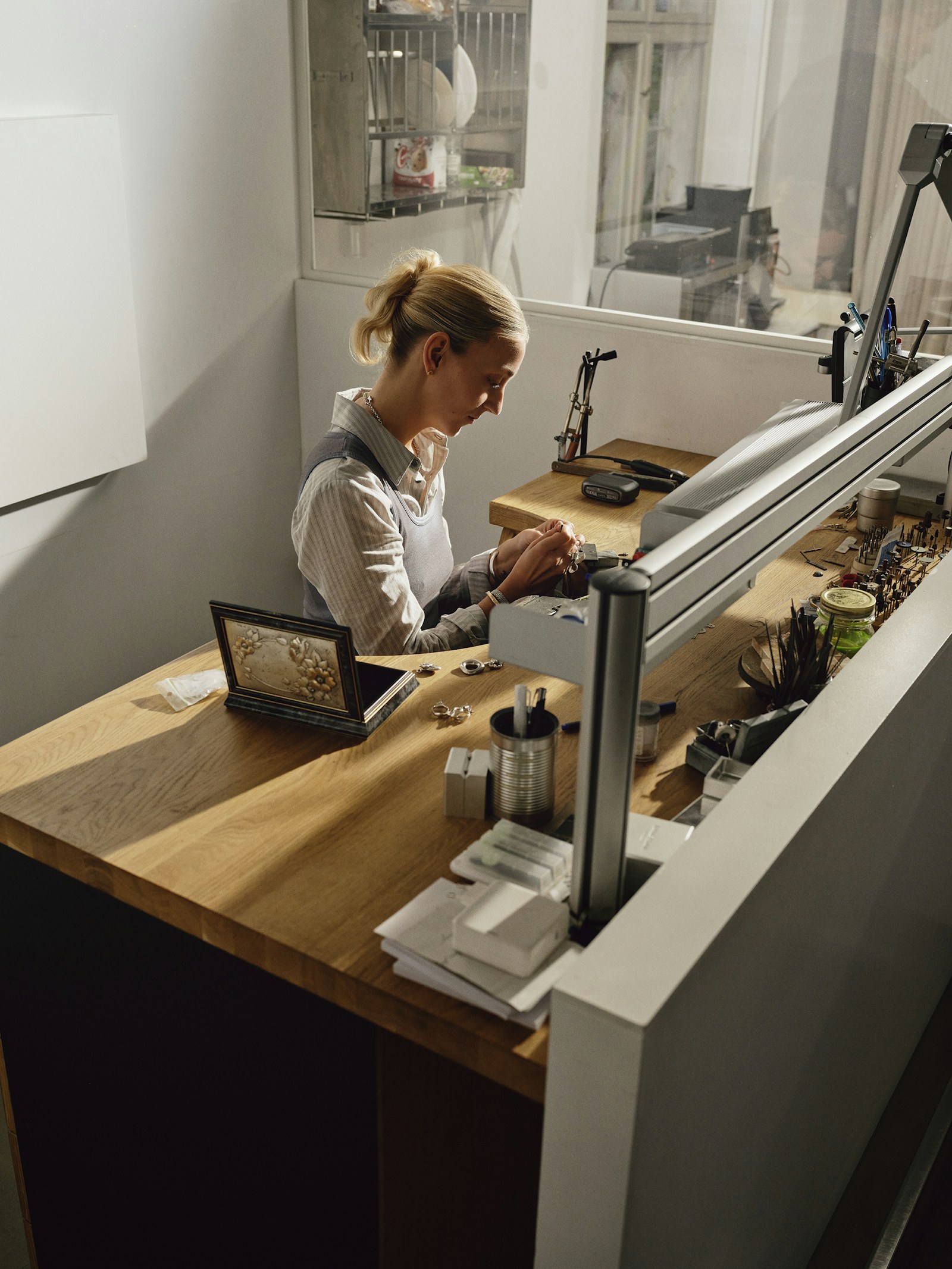 A jeweler at work at a bench