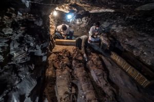 A picture taken on September 9, 2017 shows Egyptian labourers and archaeologists unearthing mummies at a newly-uncovered ancient tomb for a goldsmith dedicated to the ancient Egyptian god Amun / PHOTO / KHALED DESOUKI/AFP/Getty Images)