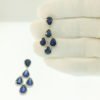 Heat treated blue sapphire, natural round brilliant diamond, halo set, dangling earrings, white gold