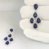 Heat treated blue sapphire, natural round brilliant diamond, halo set, dangling earrings, white gold